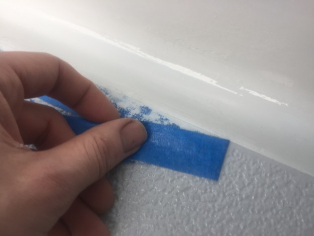 Peeling back masking tape