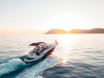 yacht moving towards the sunset